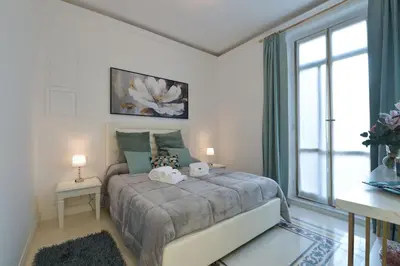 a bedroom with a bed and a large window at Trinita Rooms in Rome