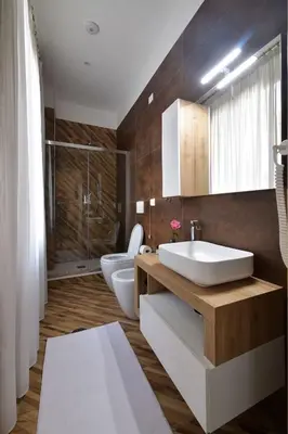 a bathroom with two sinks and a toilet and a shower at Trinita Rooms in Rome