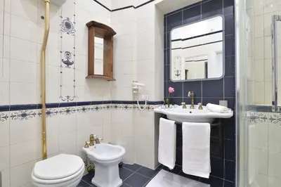 a bathroom with a toilet and a sink at Trinita Rooms in Rome