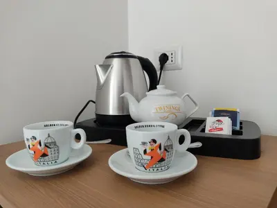 three coffee cups sitting on a counter with a coffee maker at Massimi City Garden in Rome