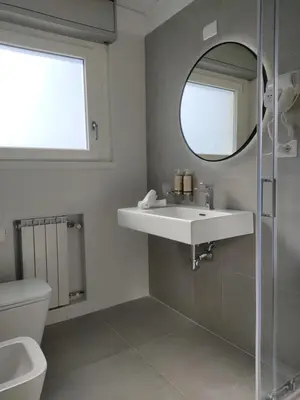 a bathroom with a sink and a mirror at Massimi City Garden in Rome
