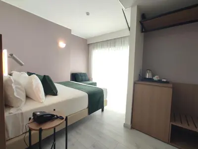 a hotel room with a bed and a chair at Massimi City Garden in Rome