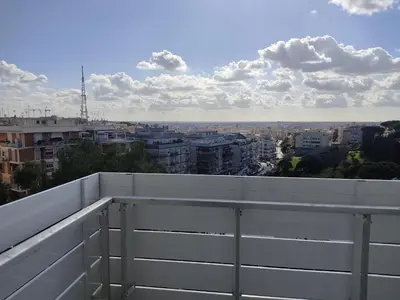 a balcony with a view of a city at Massimi City Garden in Rome