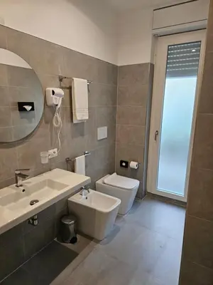 a bathroom with a sink and a toilet at Massimi City Garden in Rome