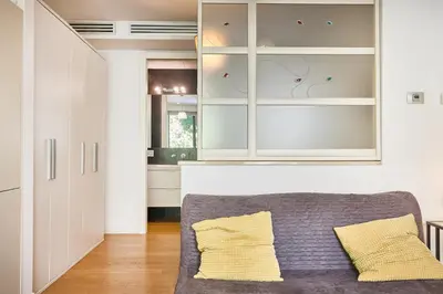 a living room with a couch and a kitchen at Hella Urbana 152 in Rome