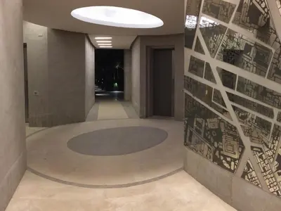 a hallway in a building with a wall with drawings on it at Hella Urbana 152 in Rome