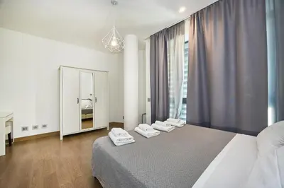 a bedroom with a bed and a large window at Hella Urbana 152 in Rome