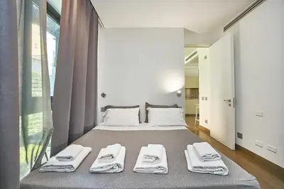 a bedroom with a bed with two towels on it at Hella Urbana 152 in Rome