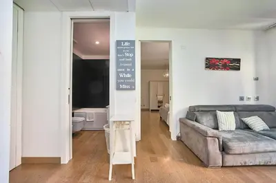 a living room with a couch and a tv at Hella Urbana 152 in Rome