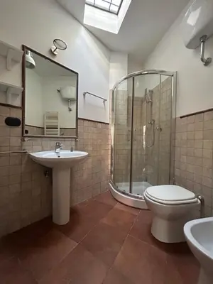 a bathroom with a shower and a toilet and a sink at èROMA - AVENTINO Apartment in Rome