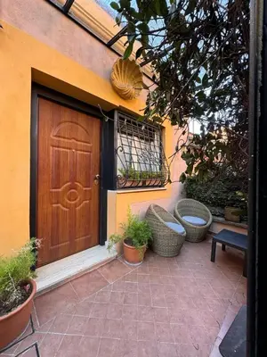 a wooden door on the side of a house with plants at èROMA - AVENTINO Apartment in Rome