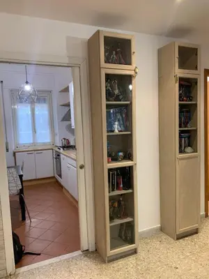 a room with a kitchen with a pantry with shelves at Valerie house Garbatella in Rome