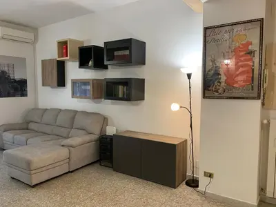 a living room with a couch and a table at Valerie house Garbatella in Rome