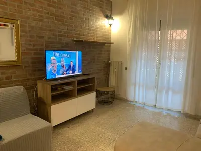 a living room with a flat screen tv on a cabinet at Valerie house Garbatella in Rome