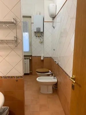 a bathroom with a toilet and a sink at Valerie house Garbatella in Rome