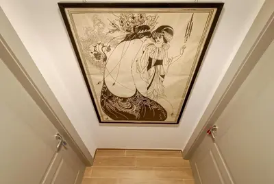 a painting of a woman on a wall next to a staircase at Little Red Apartment in Rome