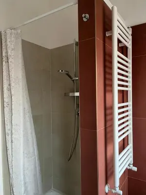 a bathroom with a shower with a shower curtain at Little Red Apartment in Rome