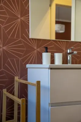 a kitchen with a counter with a sink and a mirror at Little Red Apartment in Rome