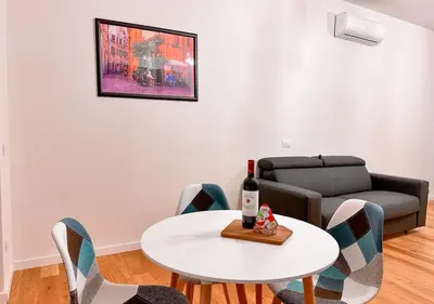 a living room with a table and a couch at Caesar's Suite Trastevere in Rome