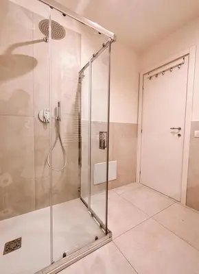 a shower with a glass door in a bathroom at Caesar's Suite Trastevere in Rome
