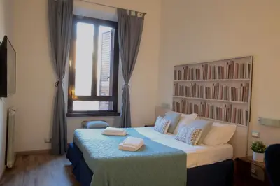 a bedroom with a bed with two towels on it at Suite Castelfidardo 50 in Rome
