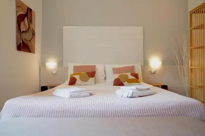 a bedroom with a white bed with towels on it at Suite Castelfidardo 50 in Rome