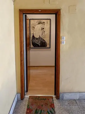 a door to a hallway with a picture on the wall at Little Blue Apartment in Rome
