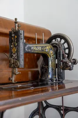 an antique sewing machine sitting on a table at Little Blue Apartment in Rome