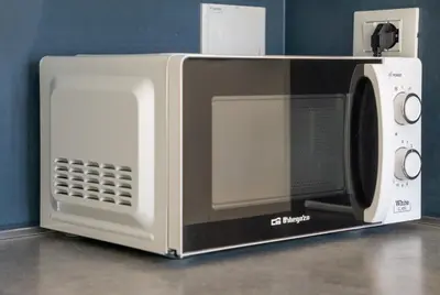 a microwave oven sitting on top of a counter at Little Blue Apartment in Rome