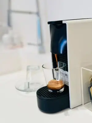 a coffee maker with a donut in it at Luxury White in Rome