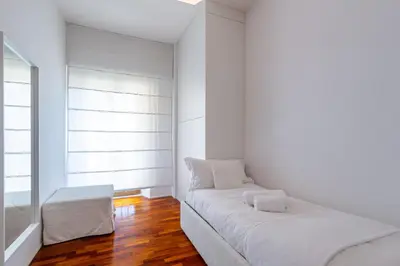 a white room with a couch and a window at Luxury White in Rome