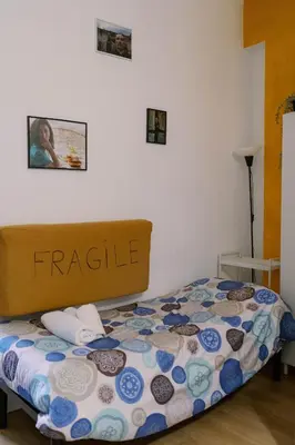 a small bedroom with a bed with a patterned mattress at La casa dell’attore - Roma Pigneto in Rome