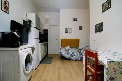 a kitchen and a living room with a washing machine at La casa dell’attore - Roma Pigneto in Rome