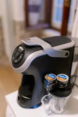 a coffee maker sitting on a counter with two cups at La casa dell’attore - Roma Pigneto in Rome