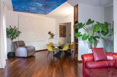 a living room with a couch and a table and chairs at Navona Luxury Flat in Rome