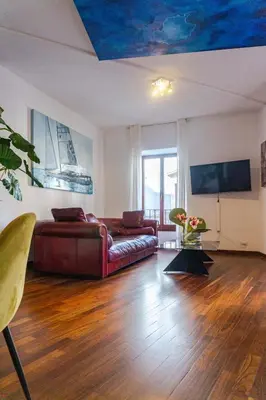 a living room with a leather couch and a tv at Navona Luxury Flat in Rome
