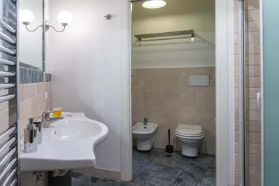 a bathroom with a shower and a white sink at Navona Luxury Flat in Rome