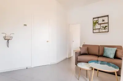 a living room with a couch and two tables at Trastevere Holiday in Rome