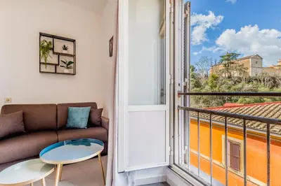 a living room with a couch and a balcony at Trastevere Holiday in Rome