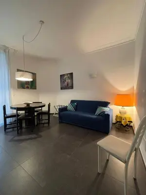 a living room with a blue couch and a table at Profumo di Sorrento a Roma in Rome