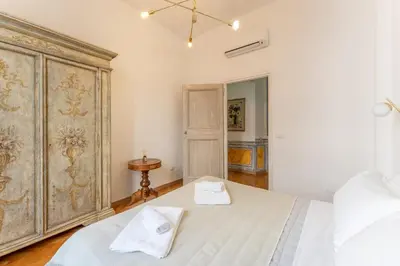 a bedroom with a large bed with two towels on it at Palazzo Pamphili Apartment in Rome