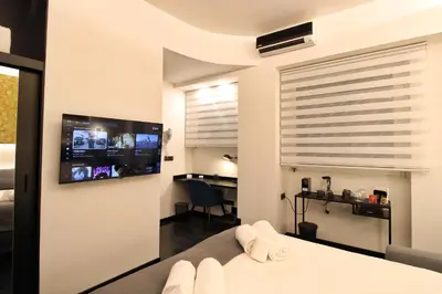 a bedroom with a bed and a tv on a wall at Roma Centro CDR Luxury Suites in Rome