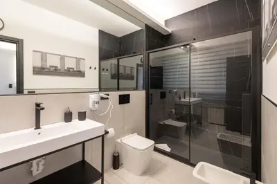 a bathroom with a sink and a toilet and a shower at Roma Centro CDR Luxury Suites in Rome