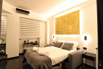 a bedroom with a bed and a painting on the wall at Roma Centro CDR Luxury Suites in Rome