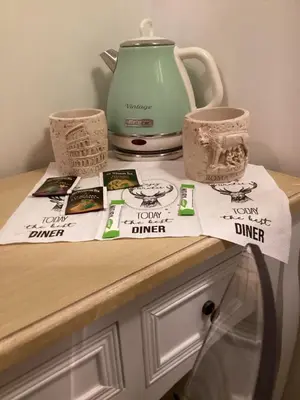 a counter with a teapot and books and cups at Bretone XI b&b in Rome