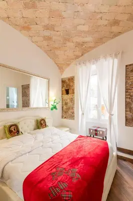 a bedroom with a large white bed with a red blanket at Bretone XI b&b in Rome