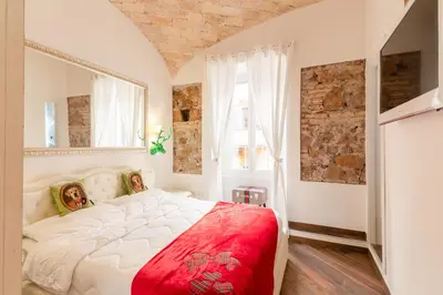 a bedroom with a large white bed with a red blanket at Bretone XI b&b in Rome