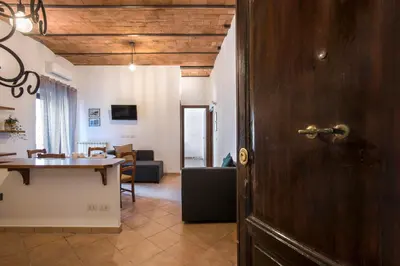 an open door to a living room with a table at Castro Pretorio Cozy apartment in Rome