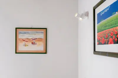 a picture of birds on a wall next to a painting at Castro Pretorio Cozy apartment in Rome