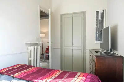 a bedroom with a bed and a dresser and a closet at Colosseo Esclusivo attico con terrazze private in Rome